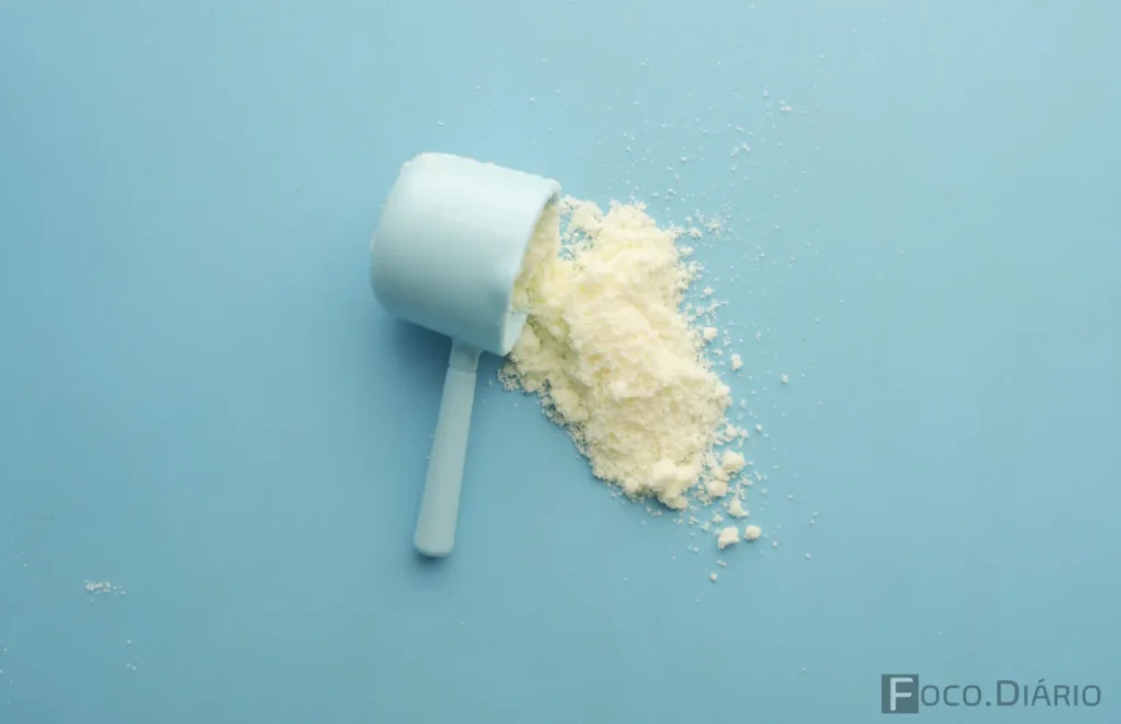 Dosador e Whey 3W caído sobre a mesa.